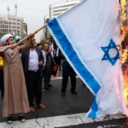 Några iranier bränner Israels flagga utanför USA:s ambassad i Teheran på söndagen, 3 november.