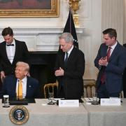 President Donald Trump, center, as Bo Hines, a member of the presidential council of advisers for digital assets, and White House AI and crypto czar David Sacks attend the White House Crypto Summit in Washington.