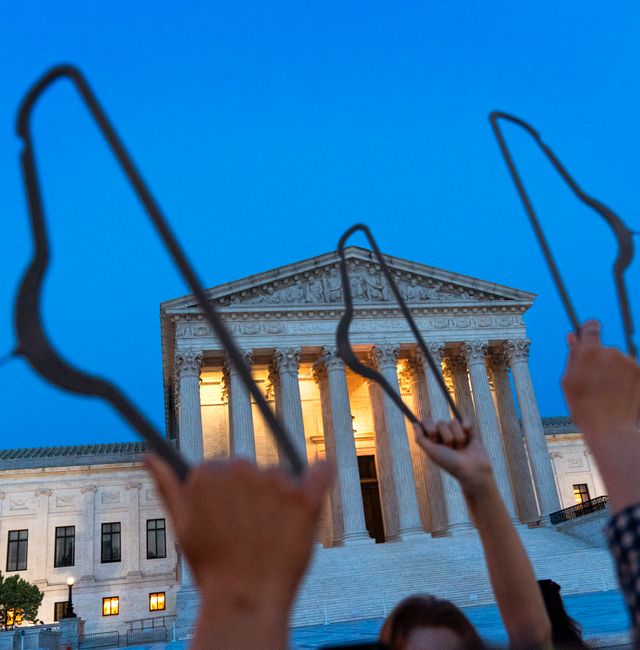 Demonstrators hold coat hangers up in the air as they protest outside of the U.S. Supreme Court, Tuesday, May 3, 2022, at dusk in Washington. A draft opinion suggests the U.S. Supreme Court could be poised to overturn the landmark 1973 Roe v. Wade case that legalized abortion nationwide, according to a Politico report released Monday. Whatever the outcome, the Politico report represents an extremely rare breach of the court's secretive deliberation process, and on a case of surpassing importance. Jacquelyn Martin / AP