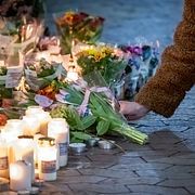 Blommor och ljus vid en butik på Bellevuegården i Malmö på onsdagskvällen efter att en kvinna i 50-årsåldern knivhuggits till döds på förmiddagen.