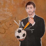 A mural depicting Juventus president Andrea Agnelli making a hole in a football with a knife, appeared in Rome, Thursday, April 22, 2021. Juventus was one of the three Italian soccer clubs among the founding members of the now defunct project to give life to a "Super League" of European clubs.
