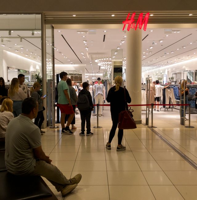 People line up to enter an H&M shop and buy items on sale in the Aviapark shopping mall in Moscow, Russia, Tuesday, Aug. 9, 2022. Alexander Zemlianichenko / AP