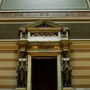 Texten ”Tänka fritt är stort men tänka rätt är större” över ingången till aulan i Uppsala universitetshus.