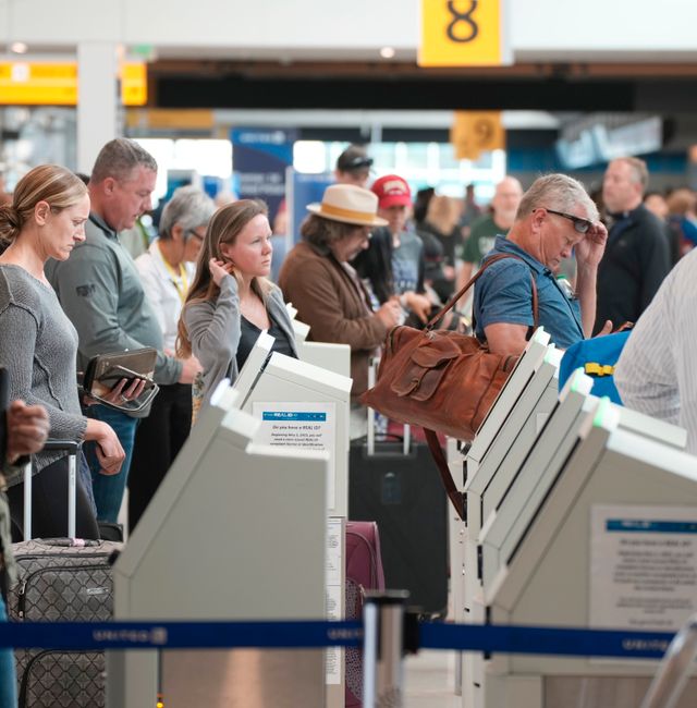 Travelers check in at self-ervice kiosks at the United Airlines counter in the main terminal of Denver International Airport, Thursday, May 26, 2022, in Denver. Experts are expecting a flush of travelers at airports and on the nation's byways during the long Memorial Day weekend, which marks the start of the summer travel season, in spite of high fuel costs.  David Zalubowski / AP