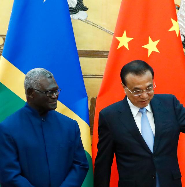 Solomon Islands Prime Minister Manasseh Sogavare, left, and Chinese Premier Li Keqiang attend a signing ceremony at the Great Hall of the People in Beijing, on Oct. 9, 2019. In an announcement Thursday, March 31, 2022, China and the Solomon Islands have signed a draft version of a security pact that could see Chinese police and other forces taking up duties in the Pacific Island nation, drawing concerns from traditional partners New Zealand, Australia and the United States. Thomas Peter / AP