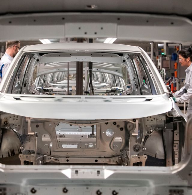 Workers complete an electric car ID.3 body at the assembly line during a press tour at the plant of the German manufacturer Volkswagen AG (VW) in Zwickau, Germany. Jens Meyer / AP