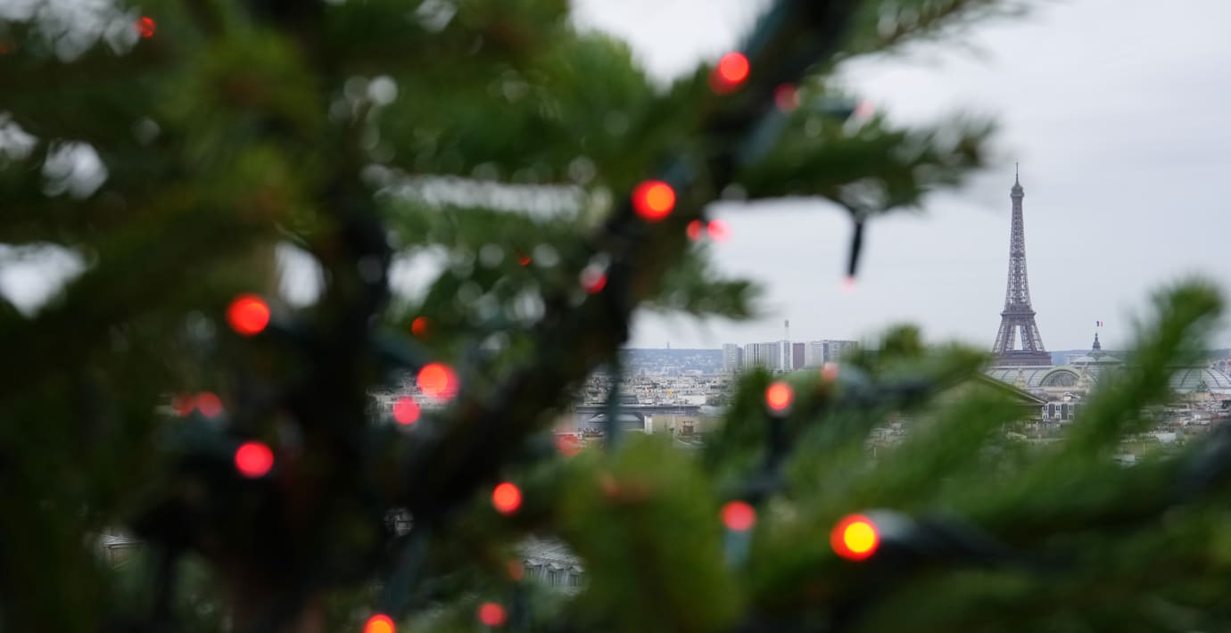 Eiffeltornet syns bakom juldekorationer i Paris. 