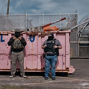 ICE-agenter utanför förvar i New Jersey, där demonstranter protesterar mot förflyttningar av förvarstagna, 26 maj 2026. 