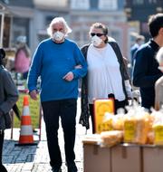 Elderly people with face mask to protect from the coronavirus go shopping at a market in Aachen, Germany, Thursday, April 9, 2020. Martin Meissner / AP