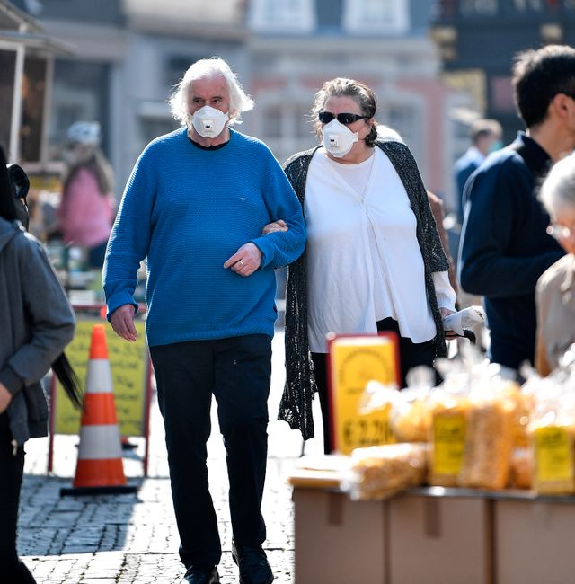 Elderly people with face mask to protect from the coronavirus go shopping at a market in Aachen, Germany, Thursday, April 9, 2020. Martin Meissner / AP
