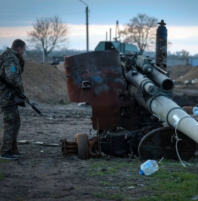 A Ukrainian soldier inspects a damaged Russian cannon in the recently retaken village Chornobaivka near Kherson, Ukraine, Tuesday, Nov. 15, 2022.  Efrem Lukatsky / AP