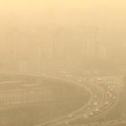 En motorväg knappt synlig under en sandstorm och stora föroreningar i Peking i mars 2023.