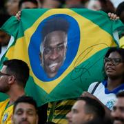 Brasiliens fans håller upp en flagga med Vinicius Juniors ansikte på.