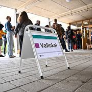 Människor köar för att rösta i vallokalen i Eriksdalshallen på valdagen.
