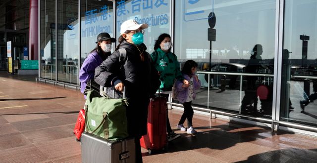 Flygpassagerare i Peking. Ng Han Guan / AP