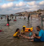 Människor söker svalka i det heta Medelhavet. Gaza City, 23 juli 2023. Fatima Shbair / AP