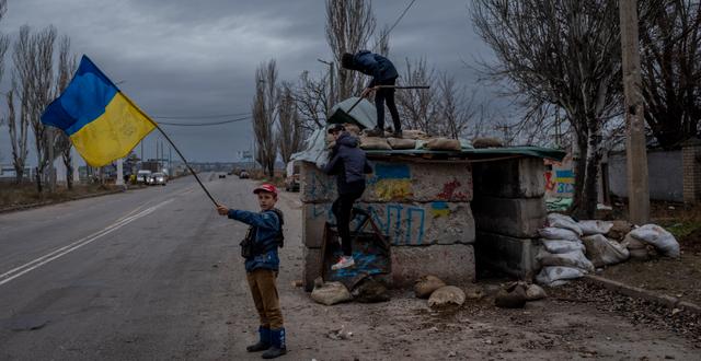 Ukrainian children play at an abandoned checkpoint in Kherson, southern Ukraine, Wednesday, Nov. 23, 2022.  Bernat Armangue / AP