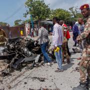 Säkerhetsstyrkor intill vraket av den bil som självmordsbombaren körde i. 