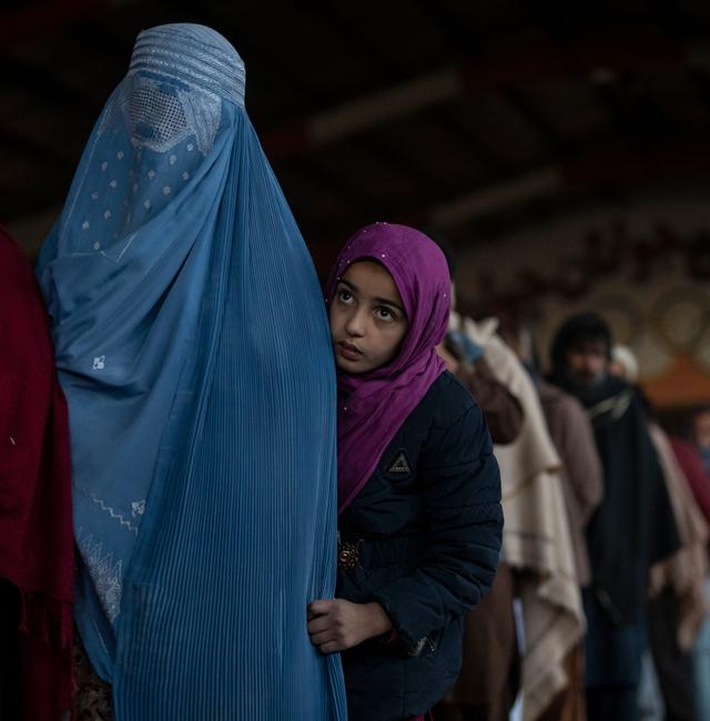 Women queue to receive cash at a money distribution site organized by the World Food Program in Kabul, Afghanistan, on Saturday, Nov. 20, 2021. Petros Giannakouris / AP