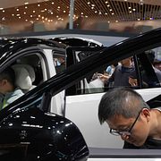 Visitors look a the latest car at the BYD booth during Auto China 2026 in Beijing, Friday, April 24, 2026. (AP Photo/Ng Han Guan)  XHG110