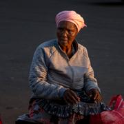 En kvinna säljer frukt och grönsaker på en marknad i Durban i östra Sydafrika. 