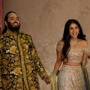Anant Ambani, left, and Radhika Merchant pose for photographers during their pre-wedding ceremony in Mumbai, July 5, 2024.