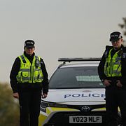 Poliser vaktar en väg i närheten av flygbasen på måndagen.